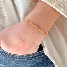 Load image into Gallery viewer, 'A Little Birthday Wish' Bracelet being worn - a gold plated star shape charm is shown on a yellow coloured silk thread