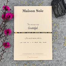 Load image into Gallery viewer, Morse Code Bead Bracelet in black spelling out 'Grateful', displayed on presentation card