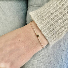 Load image into Gallery viewer, 'Love You To The Moon And Back' Wish Bracelet being worn - beige silk thread with a gold plated Moon shaped charm