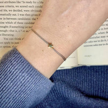 Load image into Gallery viewer, 'Thinking Of You' Wish Bracelet being worn - a grey coloured silk thread with a gold plated Star shaped charm