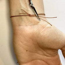 Load image into Gallery viewer, Tie your bracelet securely to fit, and then trim off any excess thread with scissors