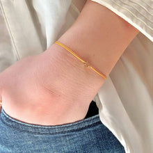Load image into Gallery viewer, &#39;A Little Birthday Wish&#39; Bracelet being worn - a gold plated star shape charm is shown on a yellow coloured silk thread
