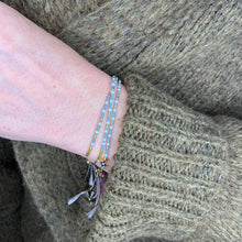 Load image into Gallery viewer, &#39;Capricorn&#39; Zodiac Morse Code bead bracelet being worn
