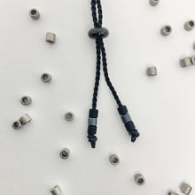 Load image into Gallery viewer, Close up detail of the sliding closing bead on the Mens Custom Made Morse Code Bracelet
