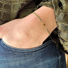 Load image into Gallery viewer, Custom Made Wish Bracelet being worn - a &#39;Moss&#39; coloured thread and the Clover shaped charm
