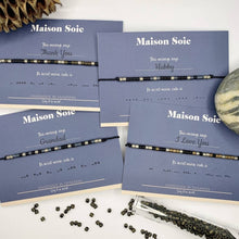 Load image into Gallery viewer, Selection of Mens Custom Made Morse Code bead bracelets displayed on cards with scattered Miyuki Beads
