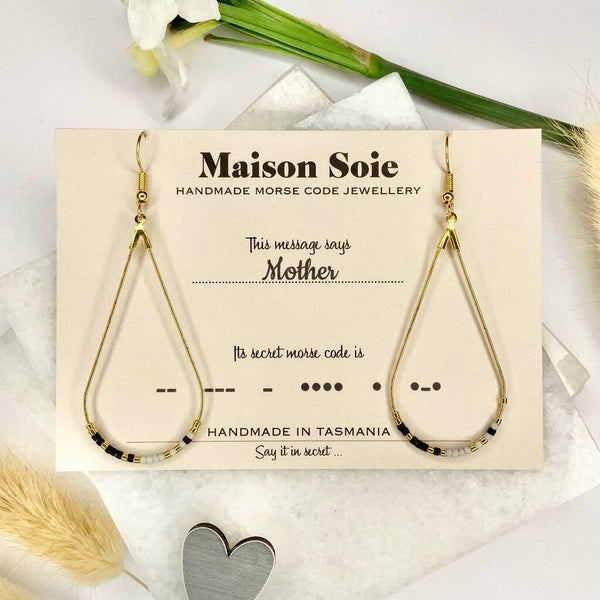 Morse Code Earrings displayed on a presentation card - the beads are arranged using Morse Code to spell out the word 'Mother'